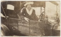 Woman seated in P.C.D.W. vehicle