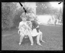 Two girls posing with puppies