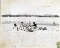 People seated on beach in Santa Cruz