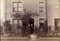 Portrait of two young children outside stone house