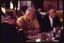 Men seated at table during meeting