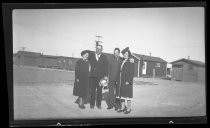 Two couples outside row of cabins