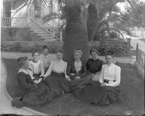 Group portrait of women under palm tree, c. 1912