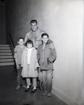 Wrestler posing with three kids