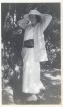 Woman posing in long skirt and cardigan in a forest