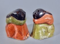 Women with their heads down salt & pepper shakers