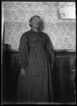 Portrait in front of floral wallpaper, c. 1906