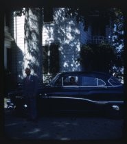 Two men with Buick in front of white house