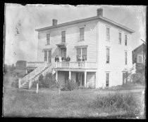 Group on porch of three-story building