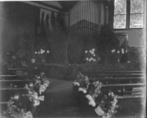 Church pews decorated with floral garlands, c. 1912