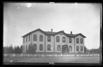 Two-story institutional building, with swingset