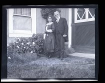 Edwin Markham and woman in front of house