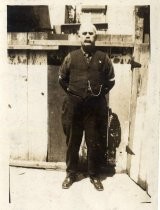 Man in front of wooden gate