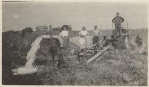 Group Pumping Water in Field