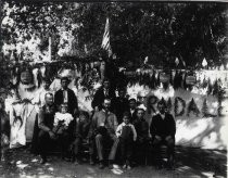 Group pose in front of an outdoor banner in the woods