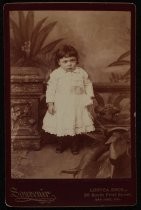 Studio portrait of young child in white dress