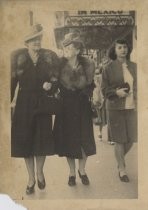 Street photograph of two women in fur stoles