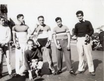 Bicycle racers posing with trophies