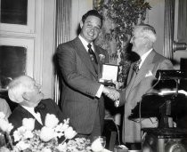 Lee de Forest seated at table at Sylvania Billionth Tube Awards