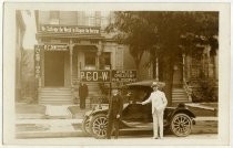 William Riker and Irvin Fisher with automobile in front of P.C.D.W. headquarters