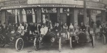 Automobiles lined up in front of the Studebaker store