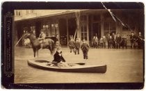 Woman in kayak on flooded street