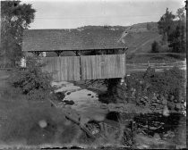 Covered bridge over rocky stream, c. 1912