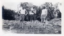 Harold Elliott with two men on banks of river