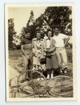 Percy Smith posing with bicycle and friends/family