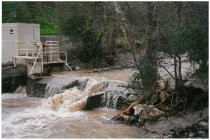 Dam on river overflowing, c. 1998