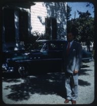 Man with Buick in front of white house