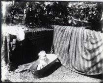 Baby in metal bathtub