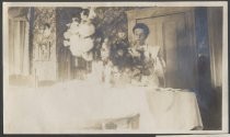 Woman with flower arrangements at table