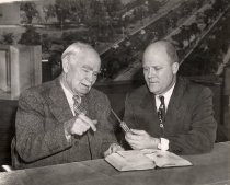 Lee de Forest and a man looking at a component