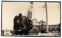 Crane lifting trolley cars headed for scrap