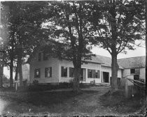 White farmhouse with shutters, and barn, c. 1912