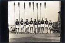 Stanford University rowing team "18" posing with oars