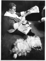 Barry York, in Santa Suit, Reading Paper