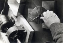 Man's hand turning radio dial, Motorola factory