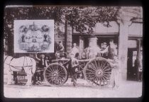 Fire engine and firemen in front of fire station