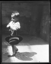 Young child carrying hat, Fiesta de las Rosas