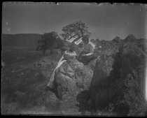 Two women seated on rocks