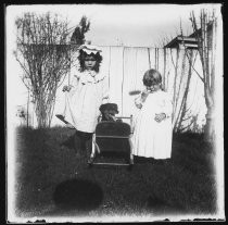 Two girls and doll carriage