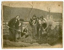 Woman planting a tree on a farm