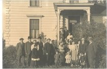 Family portrait in front of two-story home