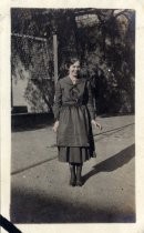 Young woman in school uniform near volleyball net