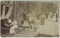 Tille Brohaska playing "Smoky Mokes" on piano, with dancers, c. 1899