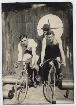 Two cyclists posed on bicycles c.1920