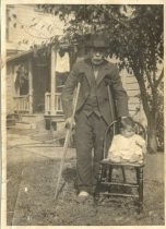 Man on crutches with baby