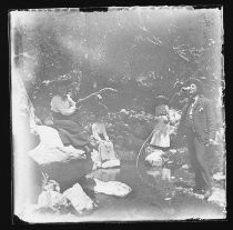 Men and women fishing on banks of creek